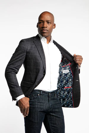 The Apollo stretch blazer is a great option to really elevate your casual sport coat game. This navy blazer with a daring yet not overstated ecru glen plaid is a fun and denim friendly jacket that will be in your rotation for years to come. Like most 7 Downie St. sport coats, the Apollo has a generous amount of stretch, allowing you to look your best without compromising comfort.