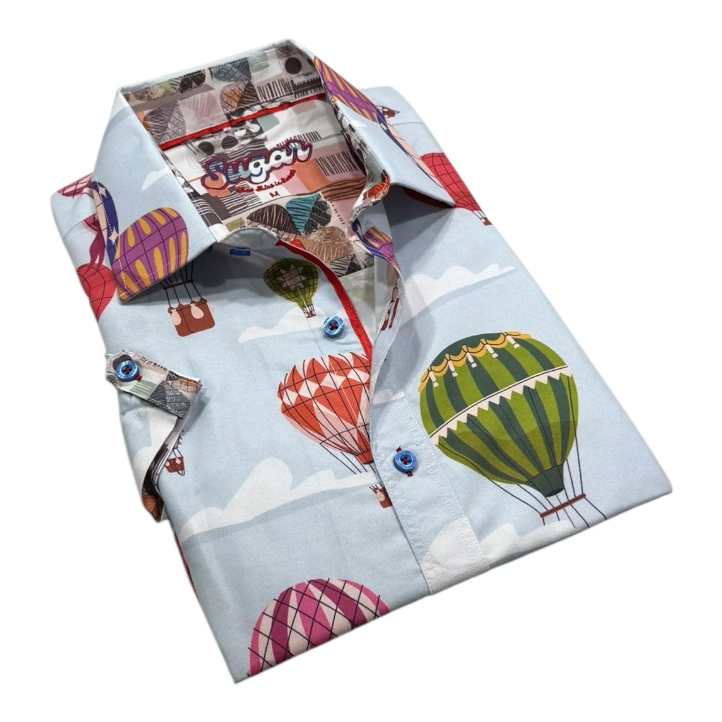 Folded shirt with hot air balloon and vintage airplane pattern on a light blue background