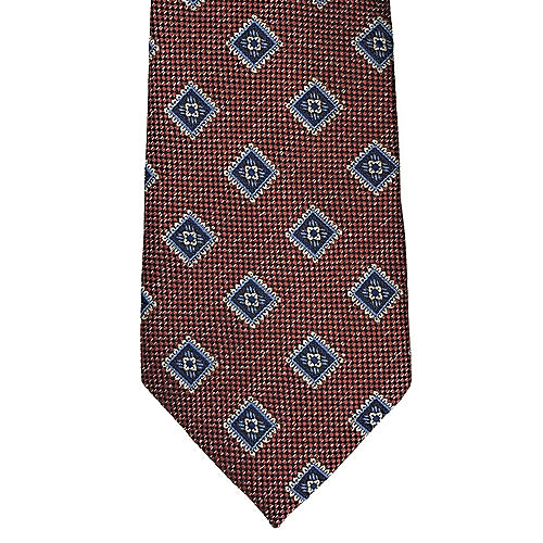 Brown tie with blue geometric pattern on a white background