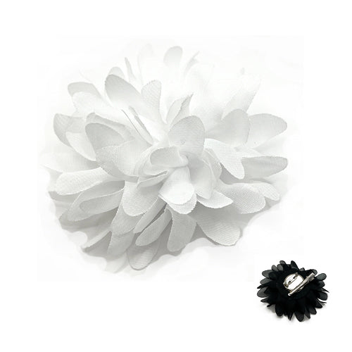 White flower hair clip and black hair accessory on a white background