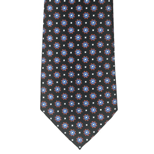 A men's necktie with a black base, featuring a repeating geometric pattern of blue and red circular medallions with small white squares.