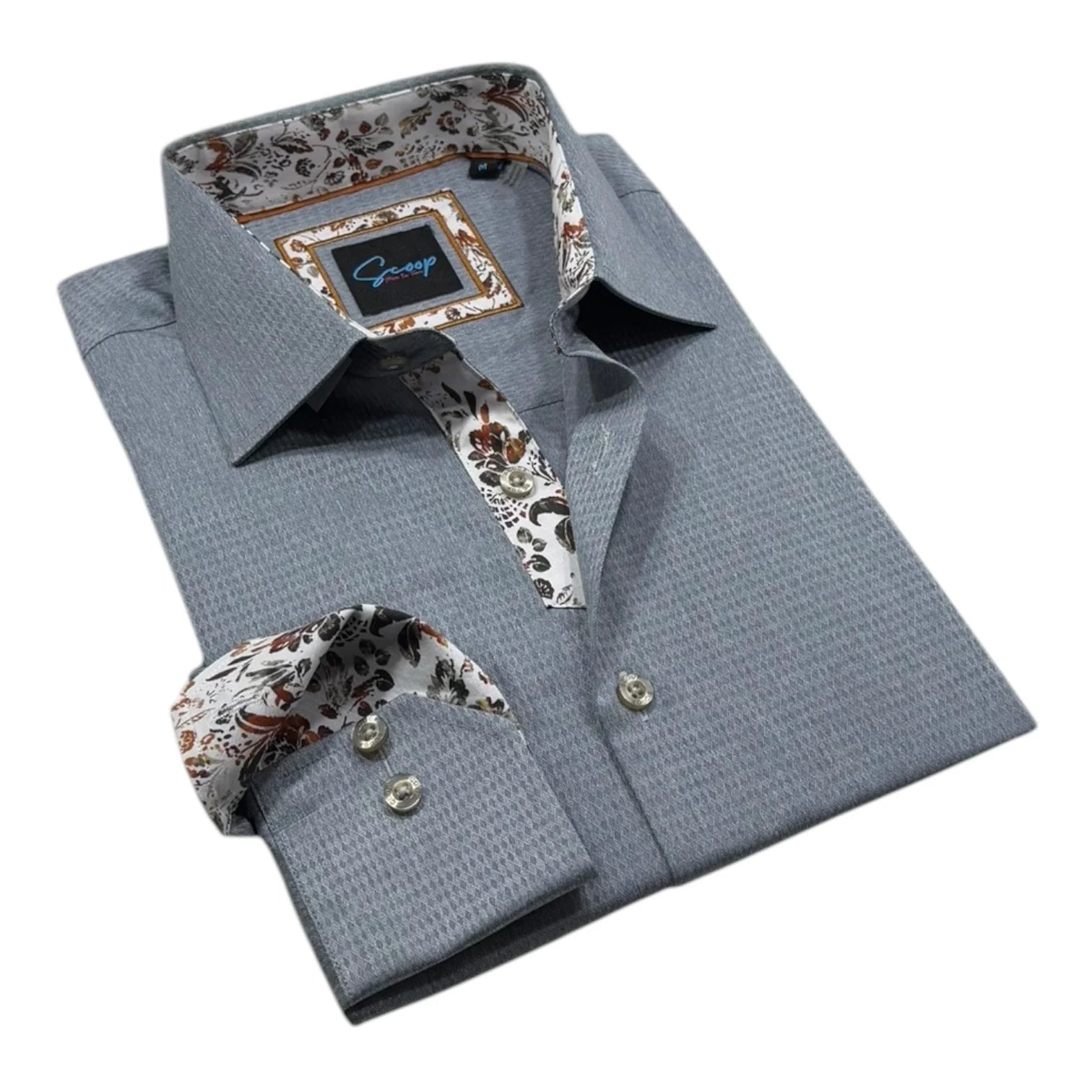 Gray dress shirt with patterned tie and pocket square on a white background