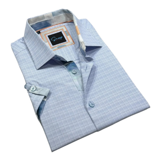 Folded light blue checkered dress shirt with a brand label on a white background