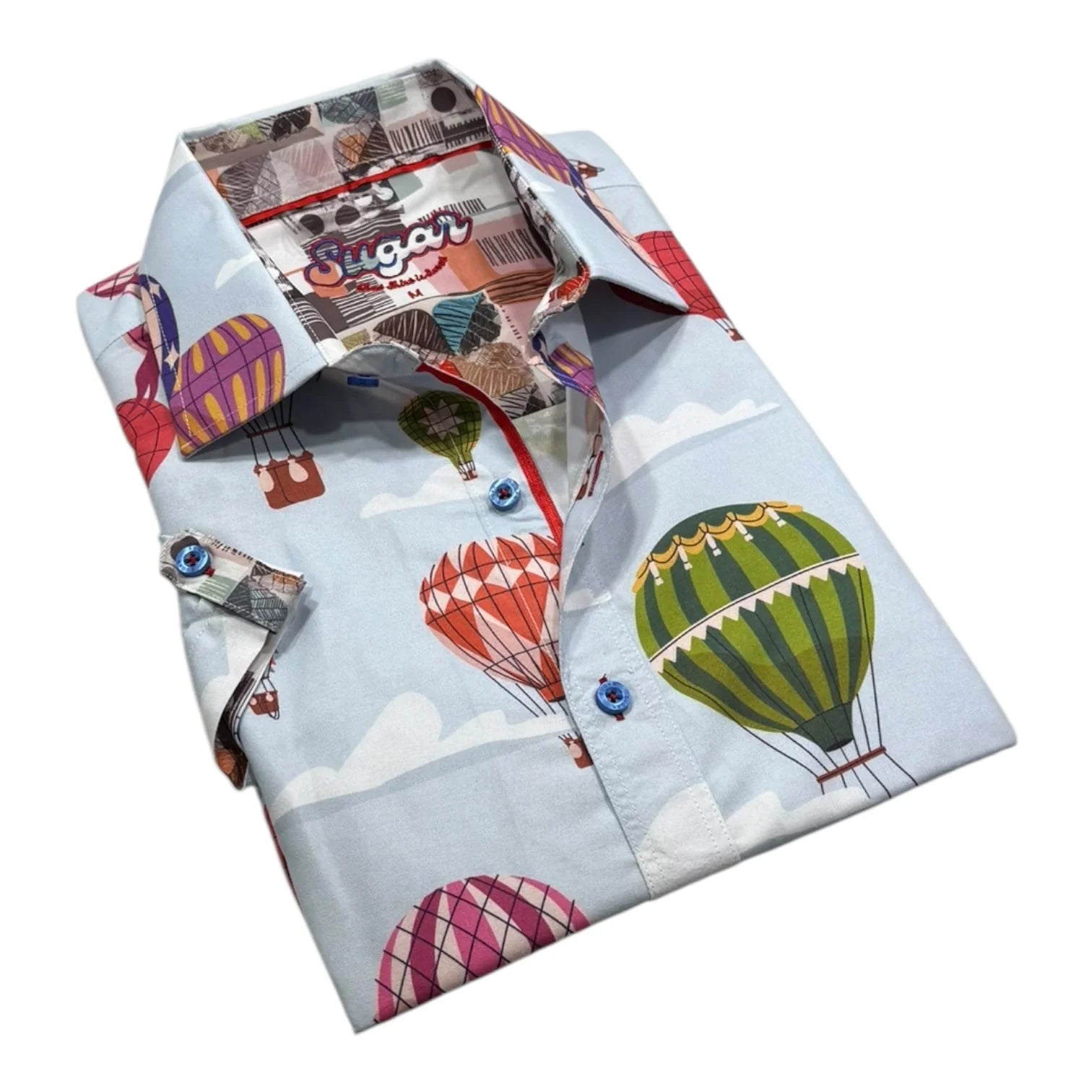 Folded shirt with hot air balloon and vintage airplane pattern on a light blue background