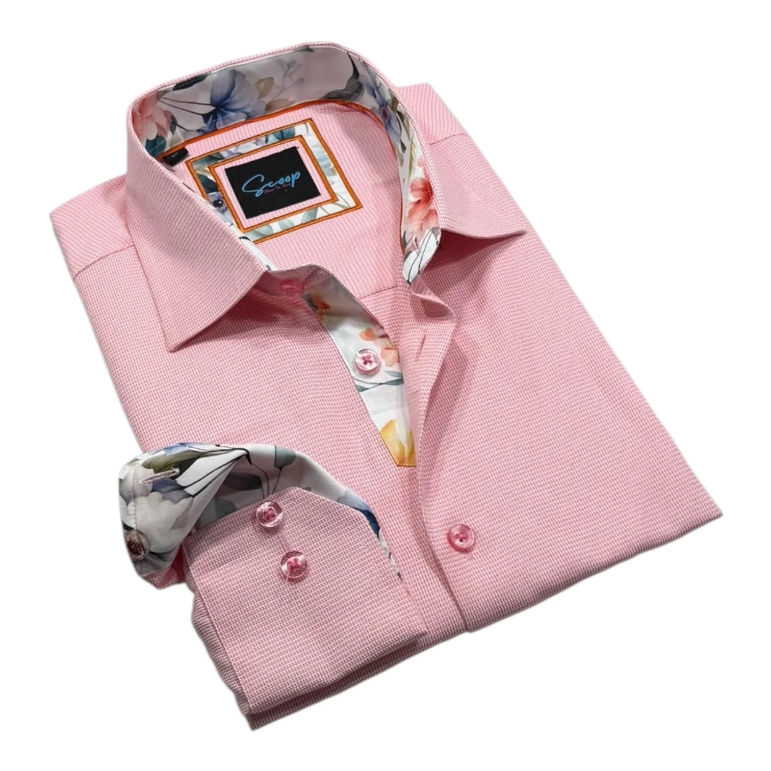 Folded pink dress shirt with floral lining on a white background