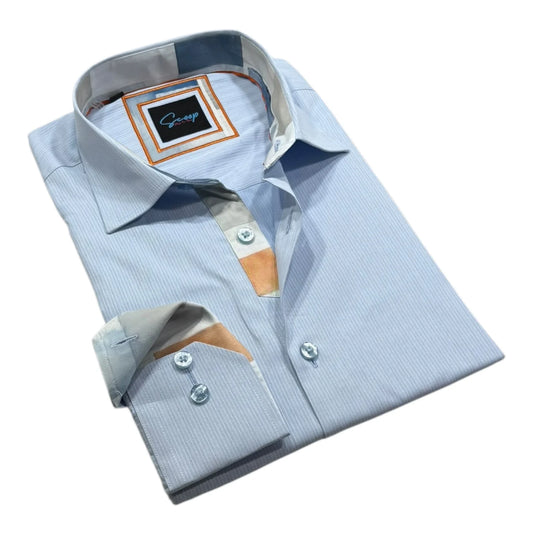 Folded light blue dress shirt with a brand label on a white background