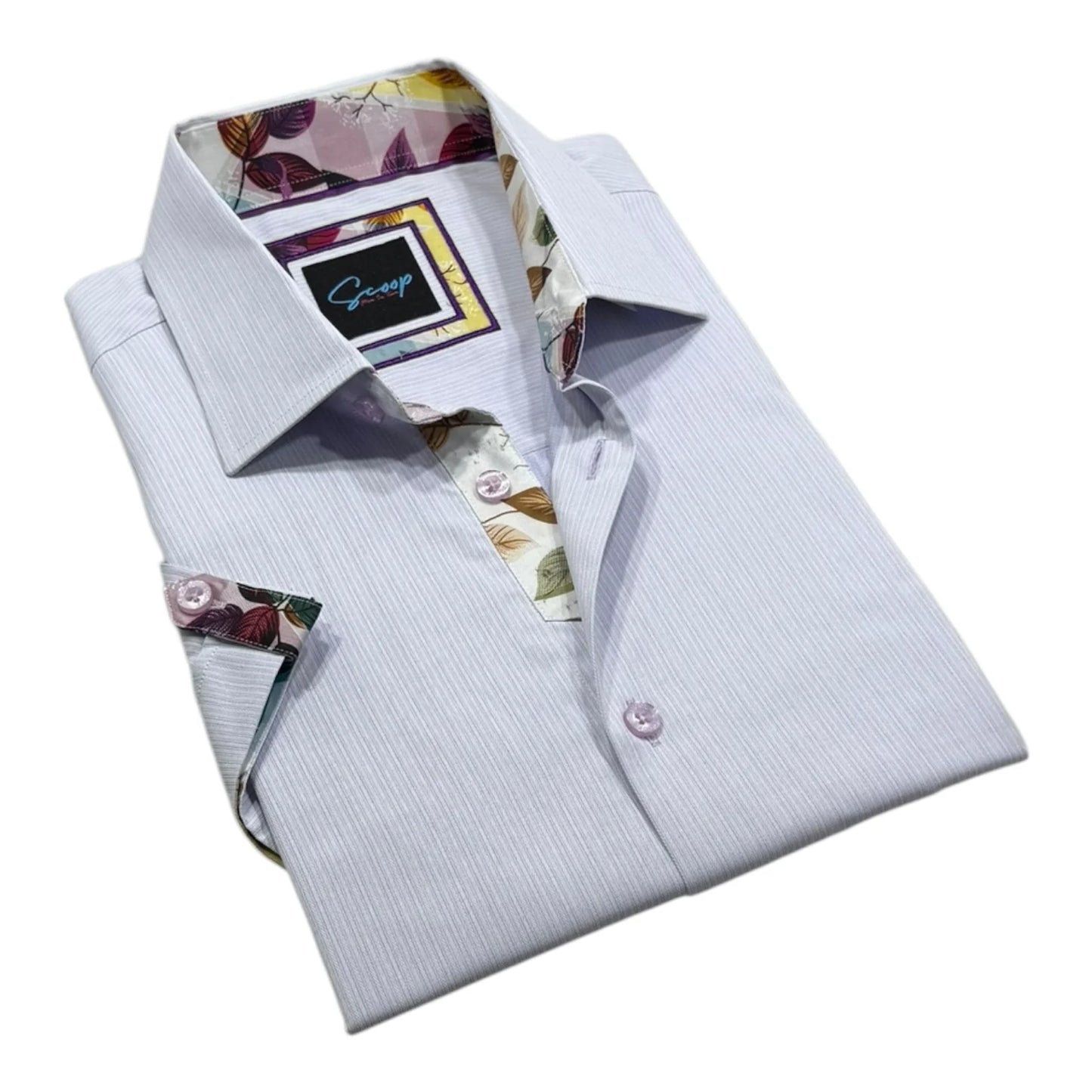 Folded light blue dress shirt with floral accents on a white background