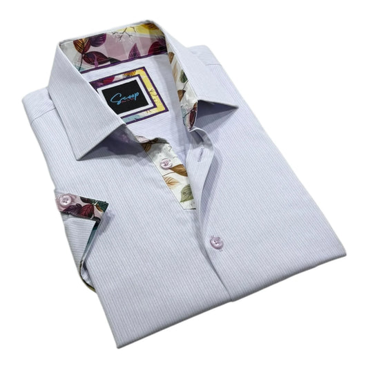 Folded light blue dress shirt with floral accents on a white background