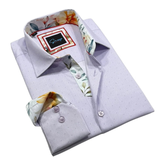Folded light purple dress shirt with floral cuffs and collar on a white background