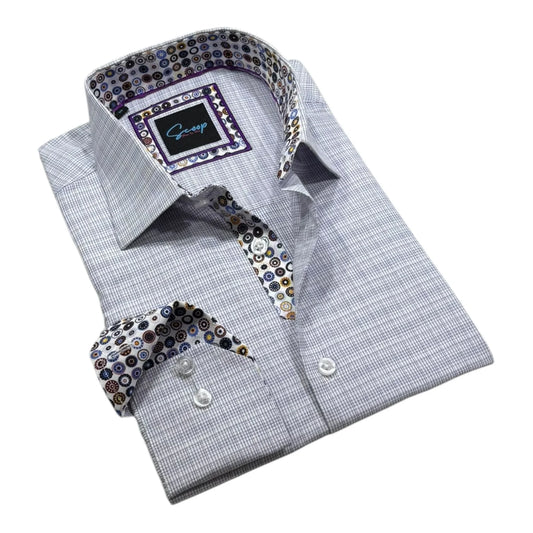 Folded gray checkered shirt with patterned tie and pocket square on a white background