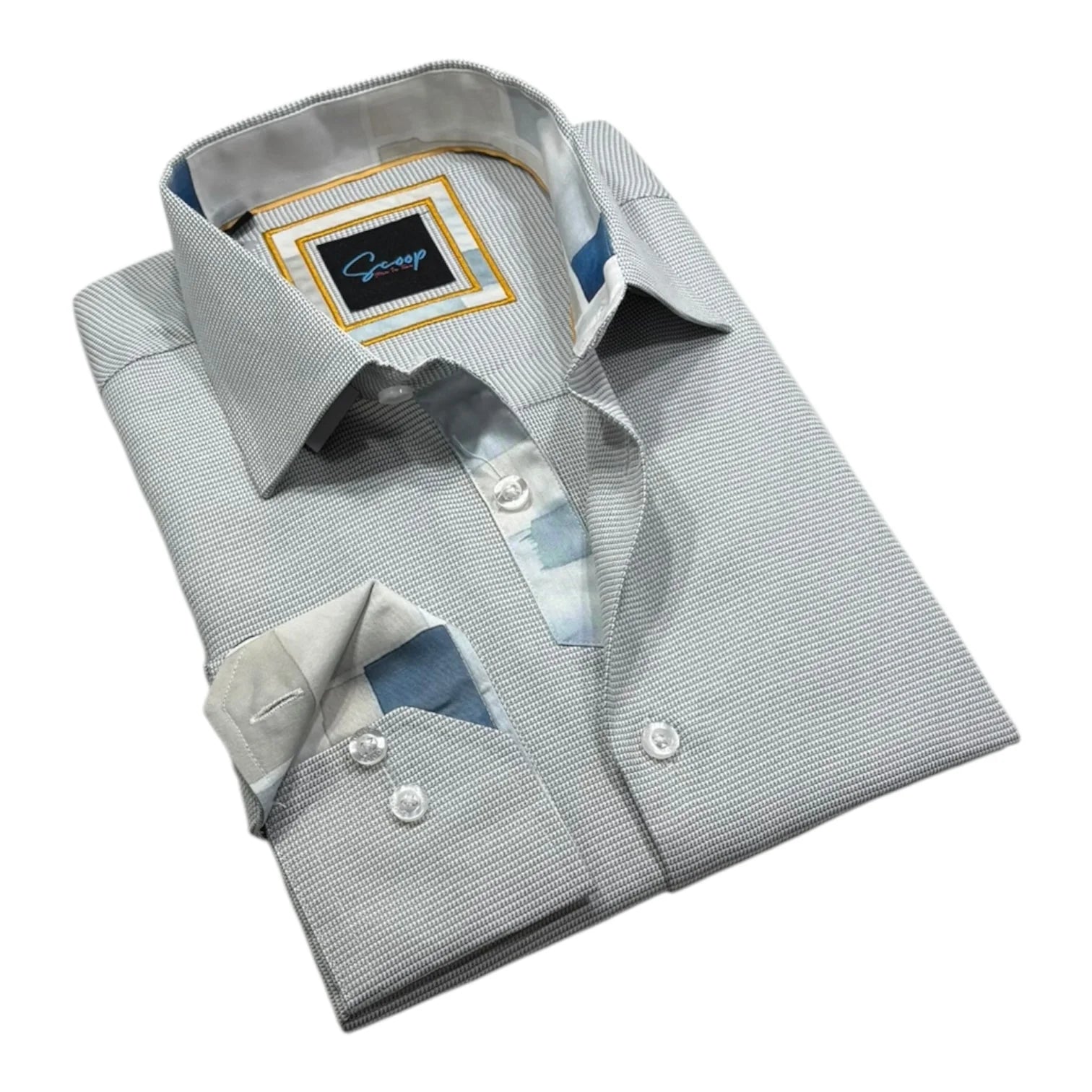 Folded dress shirt with a visible brand label on a white background