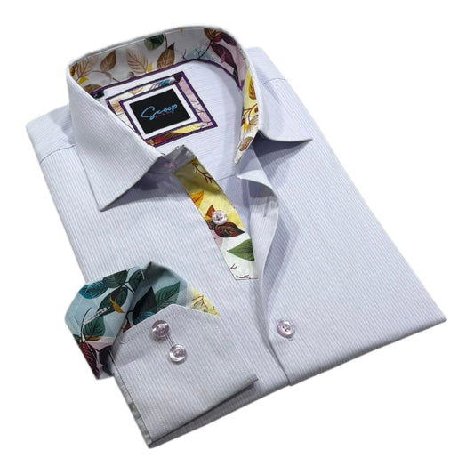 Folded light blue dress shirt with floral collar and cuff details on a white background