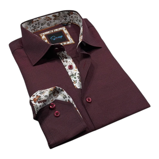 Folded maroon shirt with floral patterns on collar and cuffs against a white background