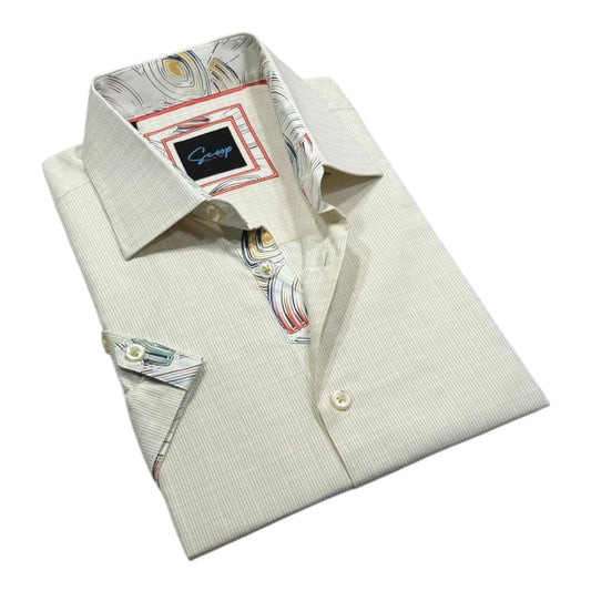 Folded light-colored dress shirt with a colorful collar pattern on a white background