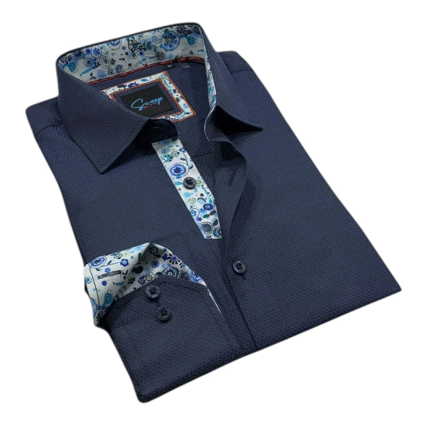 Folded navy blue dress shirt with floral accents on a white background