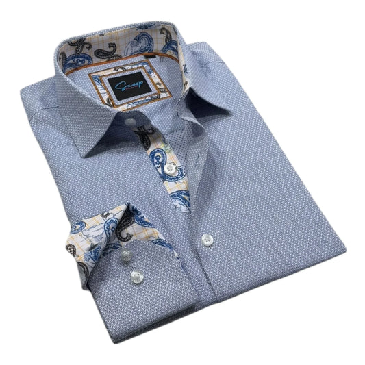Folded blue dress shirt with patterned collar and cuffs on a white background