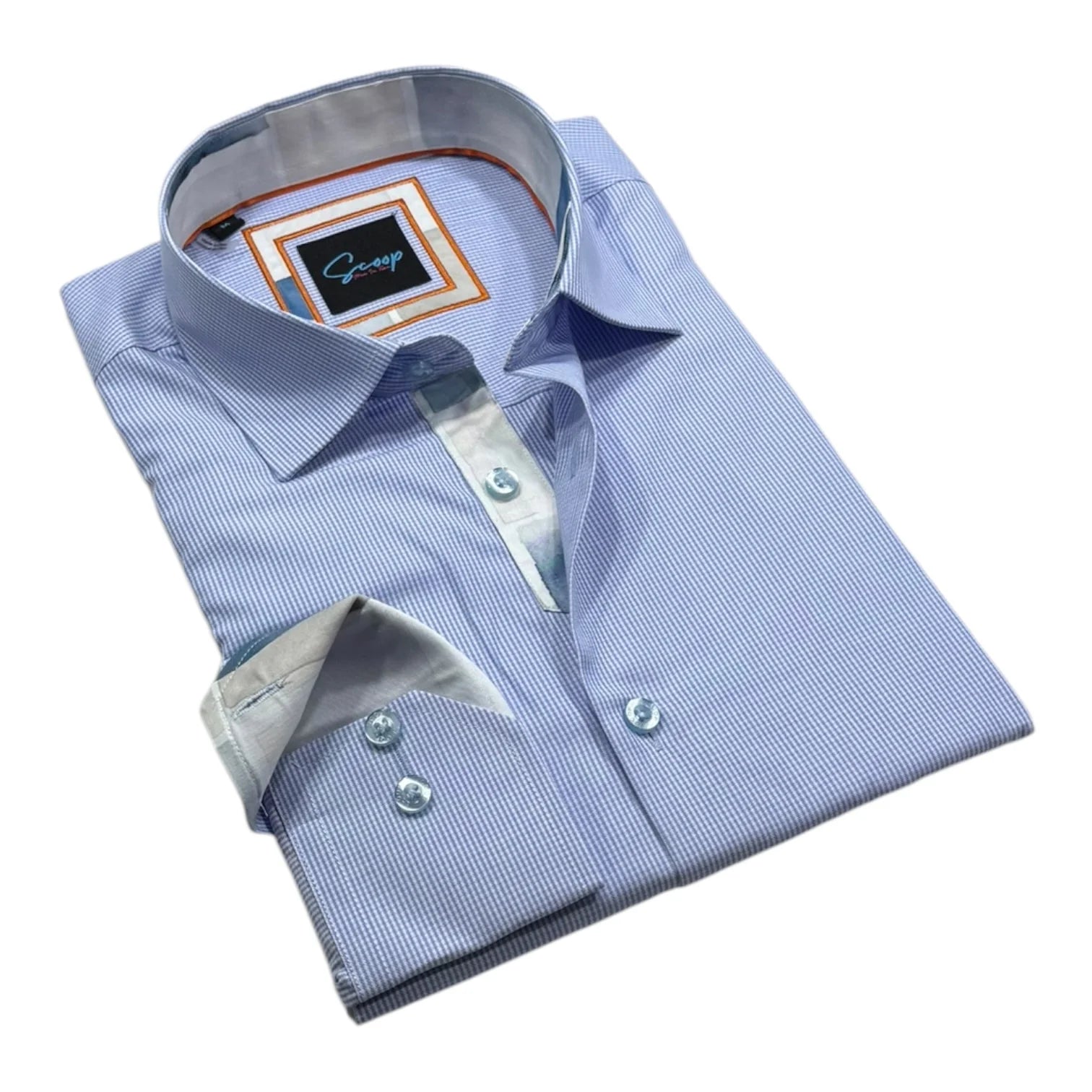 Folded light blue dress shirt with a collar tag on a white background