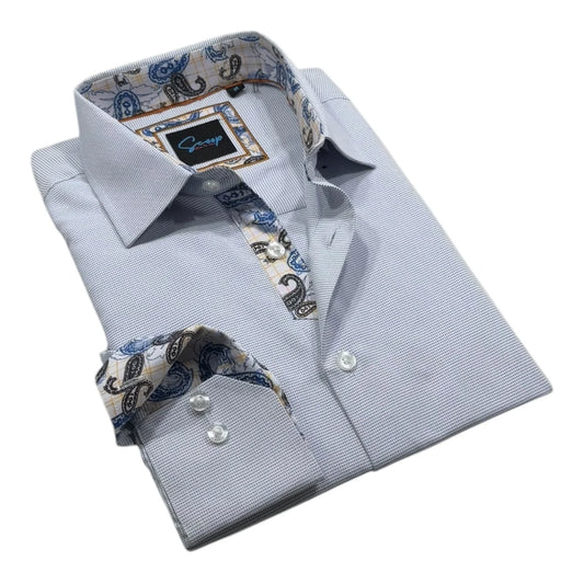 Folded light blue dress shirt with patterned inner lining and cuffs on a white background