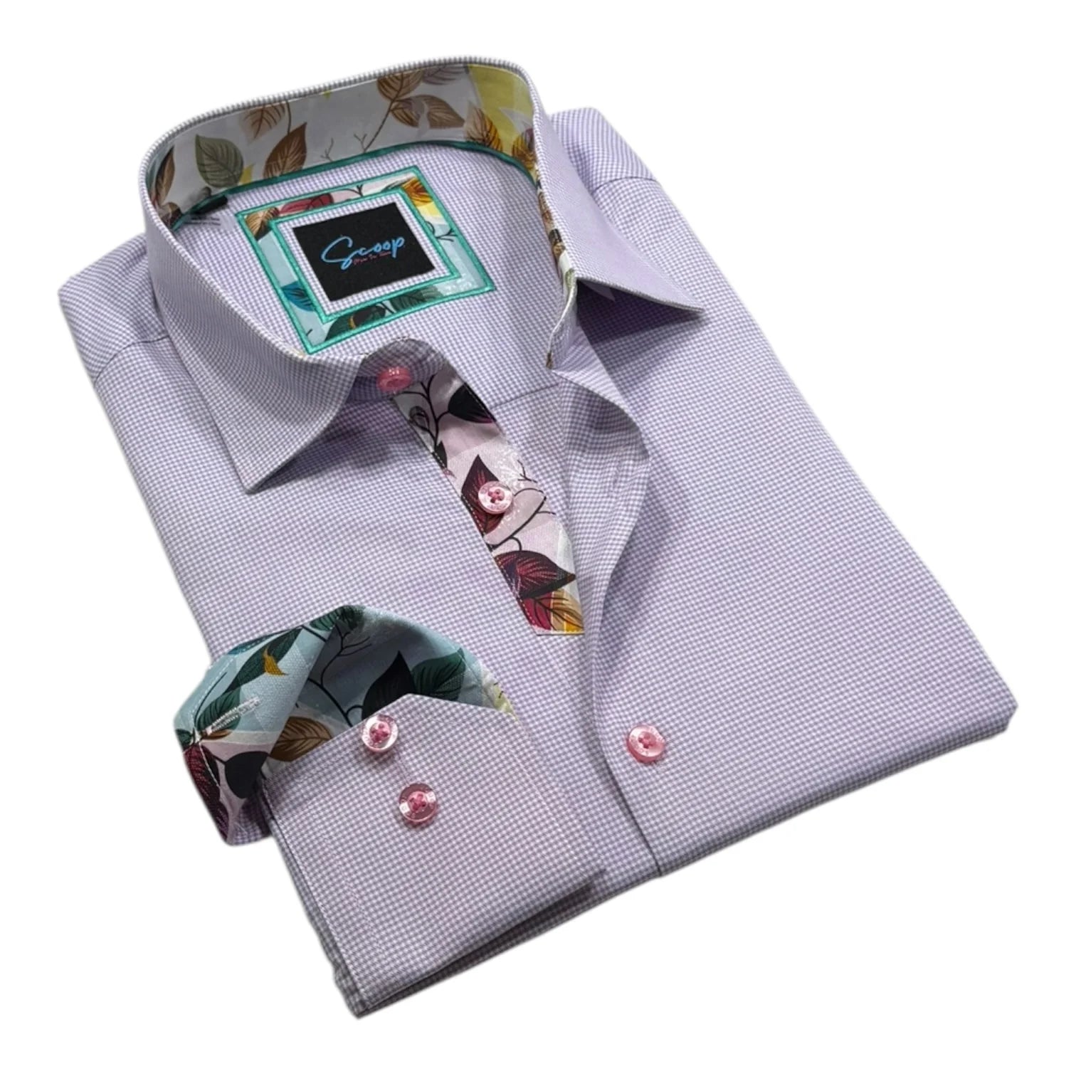 Folded light purple dress shirt with floral accents on a white background