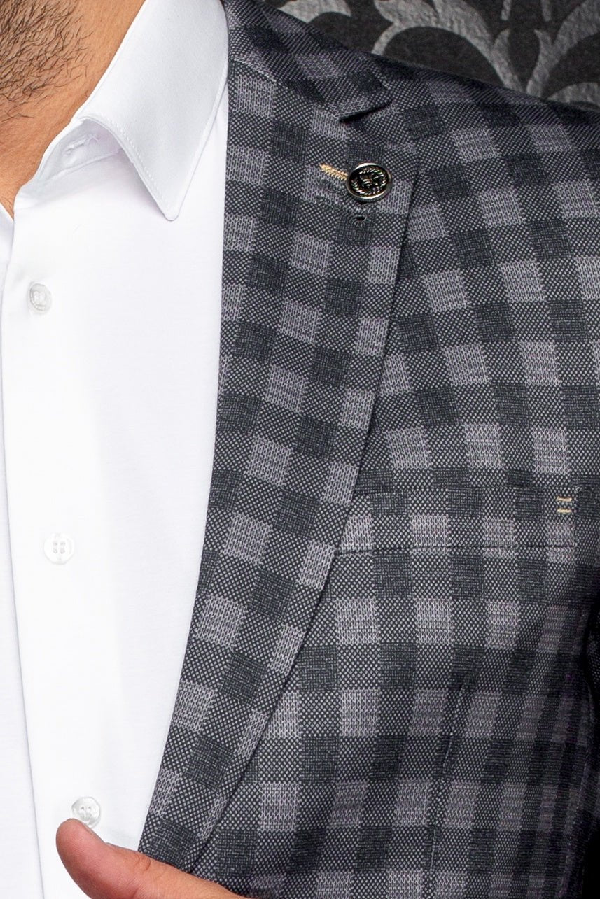 Gray checkered suit jacket worn over a white shirt
