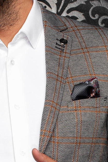 Close-up of a gray checkered suit jacket with a white shirt underneath.