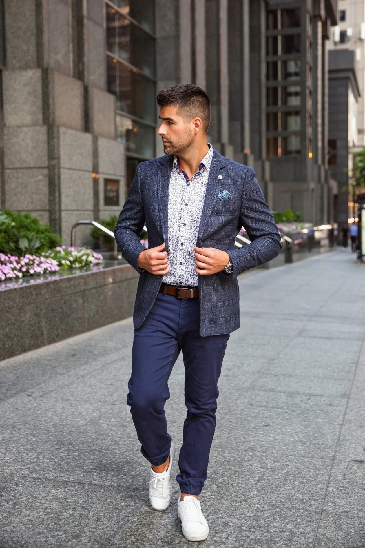 Man in a blue suit walking on a city street