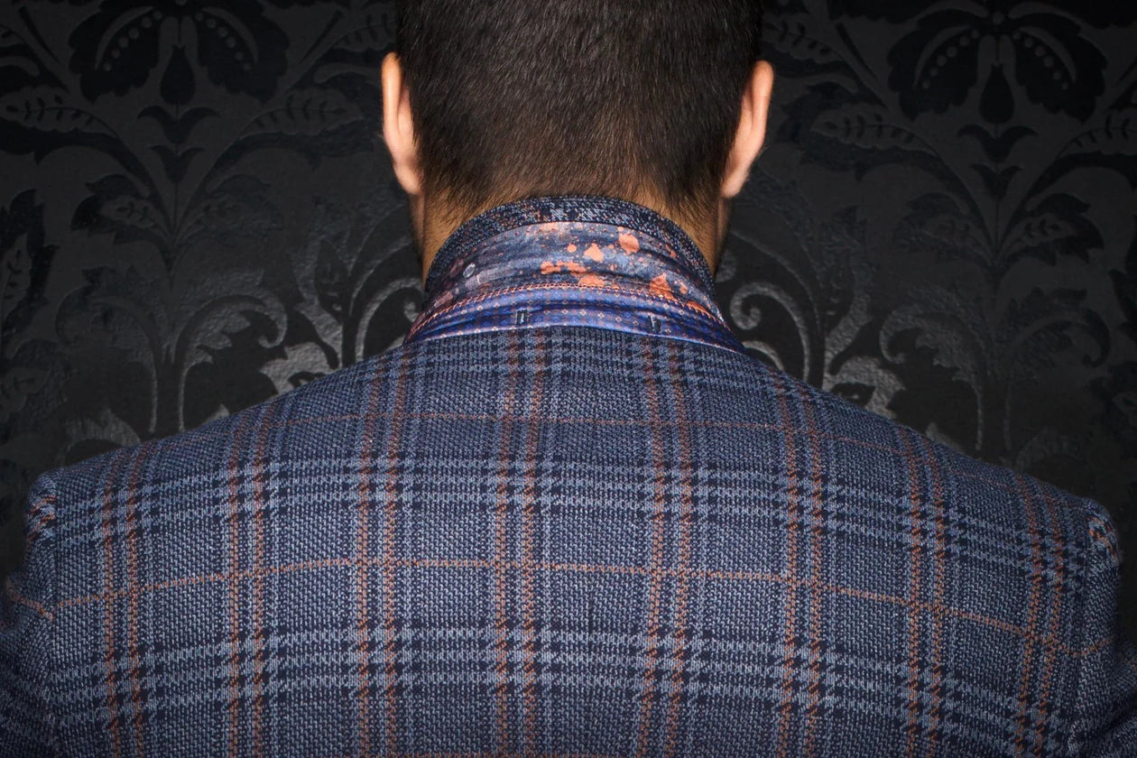 Person wearing a blue plaid jacket with a patterned background