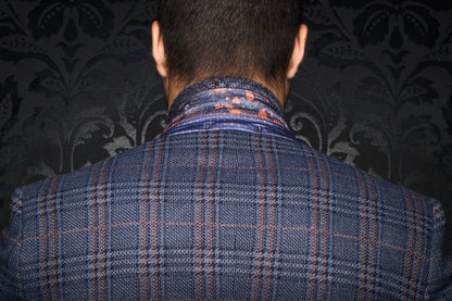 Person wearing a blue plaid jacket with a patterned background