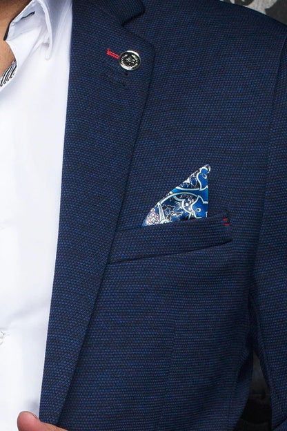 Navy blue suit jacket with a patterned pocket square and visible button.