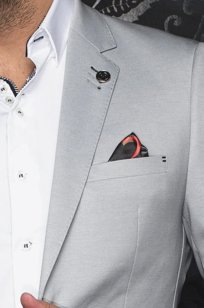 Gray suit jacket with a white shirt and red pocket square.