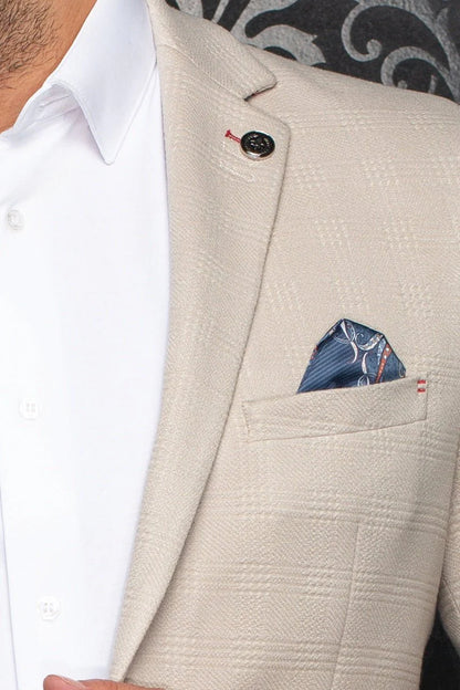 Beige blazer with a white shirt and patterned pocket square.