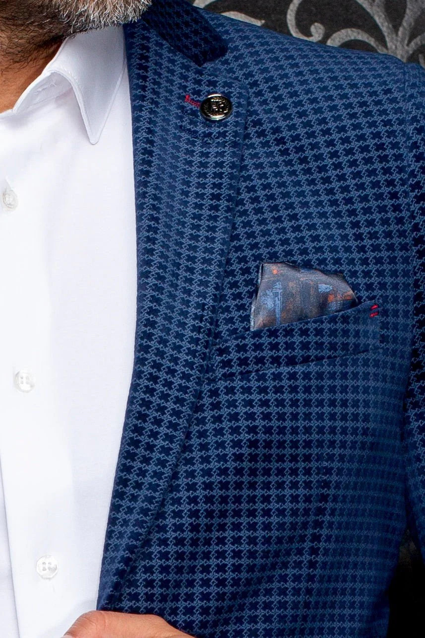 Blue patterned shirt with a pocket square worn by a person