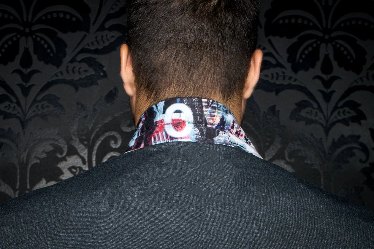 Person wearing a patterned shirt collar with a dark background