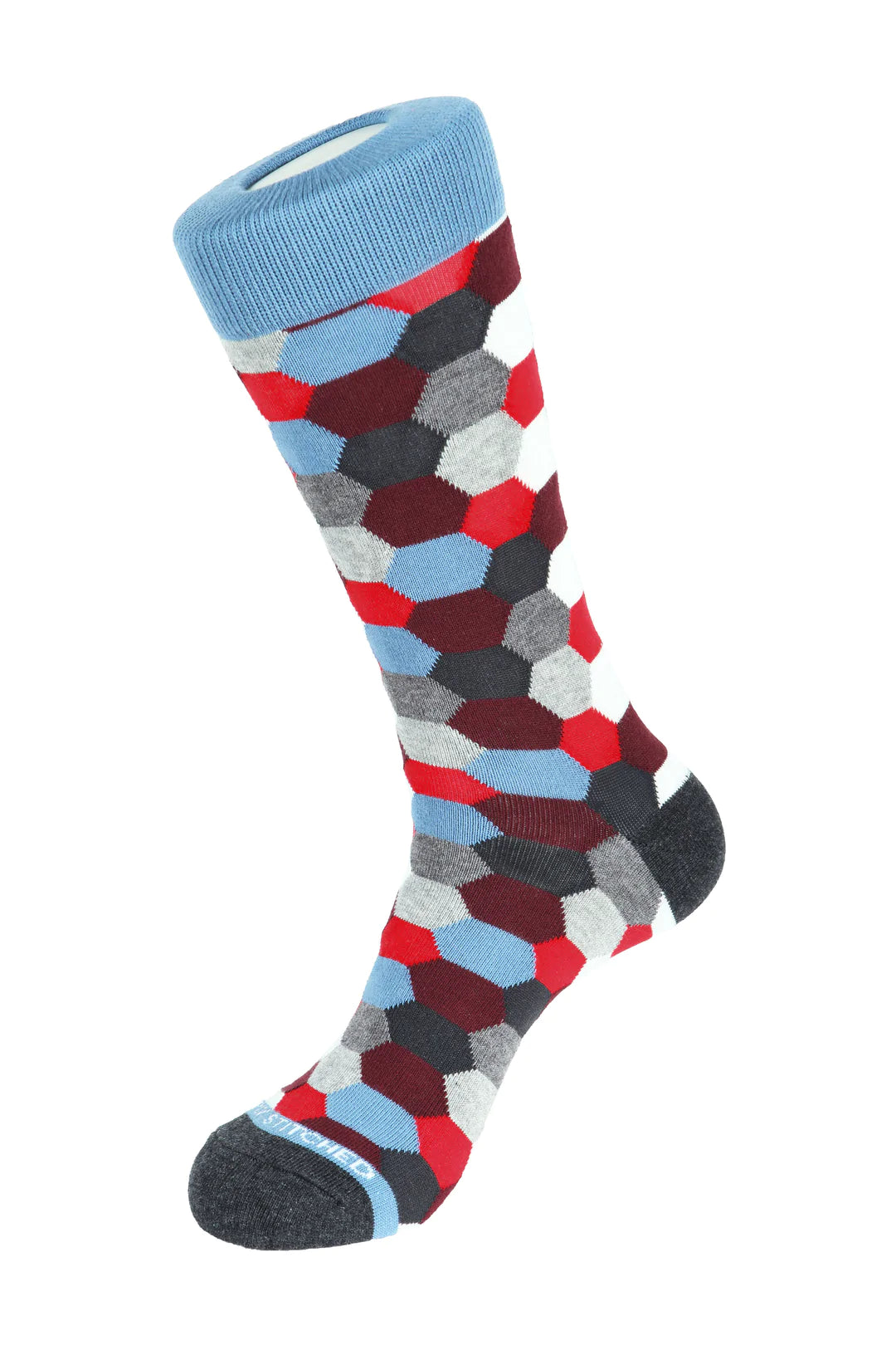 Unsimply Stitched socks with grey, red, and blue hexagon shapes, making it a great pairing with DFR89 blue denim jeans and a fun Sugar sport shirt.