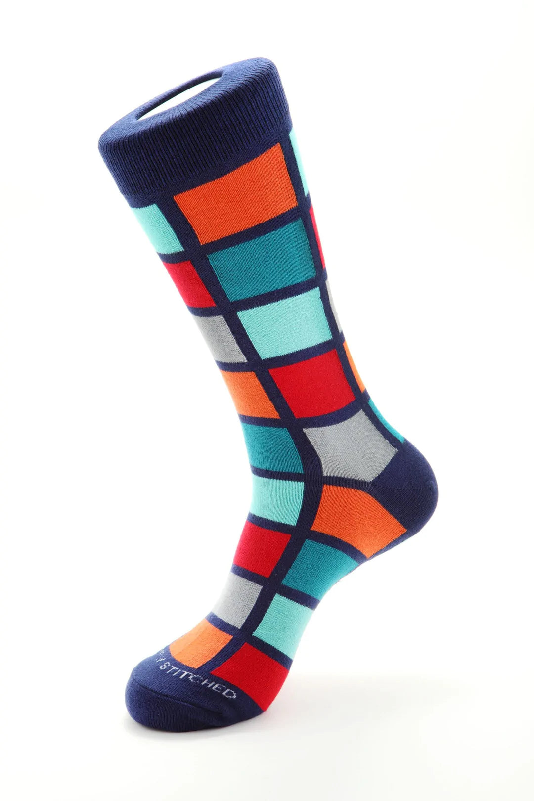 Unsimply Stitched socks with blue, orange, and multi colored square shapes, making it a great pairing with DFR89 blue denim jeans and a fun Sugar sport shirt.
